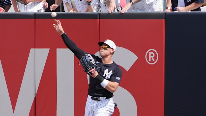 Mar 1, 2025; Tampa, Florida, USA; New York Yankees outfielder Aaron Judge (99) throws a ball to the infield hit by Houston Astros outfielder Chas McCormick (20) during the second inning at George M. Steinbrenner Field. 