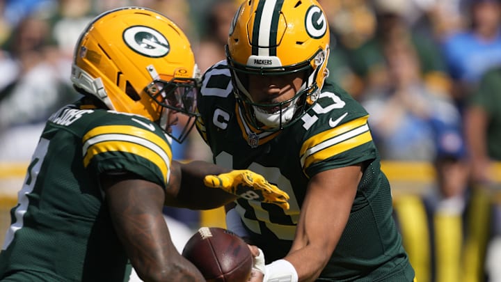 Green Bay Packers quarterback Jordan Love (10) hands off the ball to Josh Jacobs in Week 1 against the Lions.
