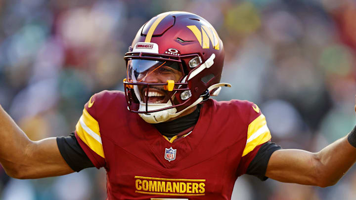Washington Commanders quarterback Jayden Daniels (5) celebrates after throwing a touchdown during the fourth quarter against the Philadelphia Eagles at Northwest Stadium. Mandatory Credit: Peter Casey-Imagn Images