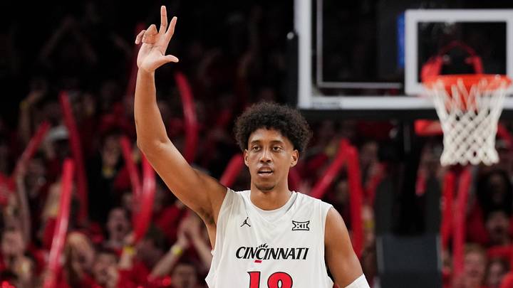 Mar 3, 2026; Cincinnati, Ohio, USA;  Cincinnati Bearcats forward Baba Miller (18) reacts to a teammate making a 3-point shot against the BYU Cougars in the first half at Fifth Third Arena. Mandatory Credit: Aaron Doster-Imagn Images