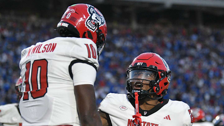 Sep 20, 2025; Durham, North Carolina, USA;  North Carolina State Wolfpack running back Darius Johnson (25) celebrates North Carolina State Wolfpack quarterback Will Wilson's (10) touchdown in the fourth quarter against the Duke Blue Devils at Wallace Wade Stadium. Mandatory Credit: Zachary Taft-Imagn Images