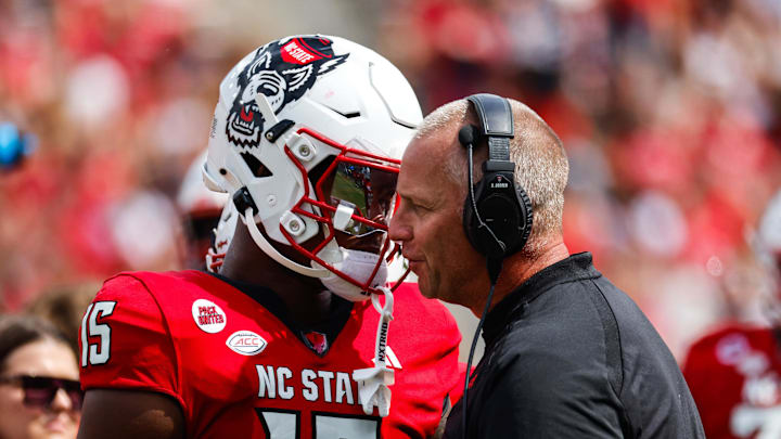 Sep 14, 2024; Raleigh, North Carolina, USA;  North Carolina State Wolfpack tight end Justin Joly (15) and head coach Dave Doeren talk during the second half against the Louisiana Tech Bulldogs at Carter-Finley Stadium. Mandatory Credit: Jaylynn Nash-Imagn Images