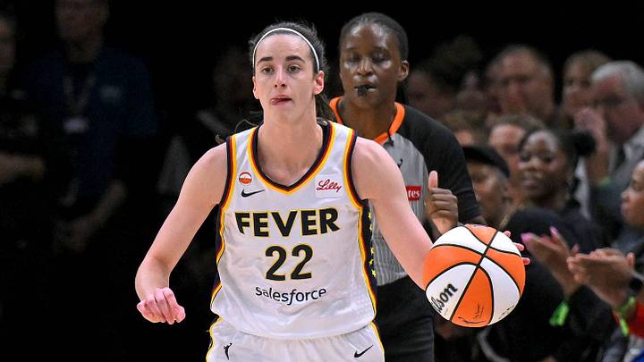 Indiana Fever guard Caitlin Clark 22 brings the ball up court during the first half of a WNBA game. Indiana Fever guard Caitlin Clark 22 brings the ball up court during the first half of a WNBA game.