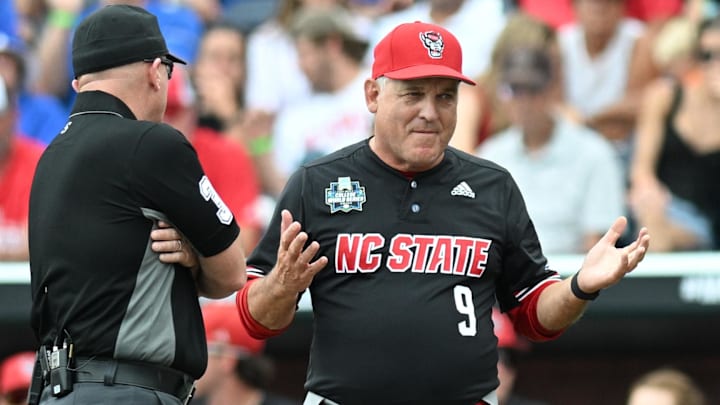 Jun 15, 2024; Omaha, NE, USA;  NC State Wolfpack head coach Elliott Avent discusses a balk call with an umpire in the game against the Kentucky Wildcats during the eighth inning at Charles Schwab Field Omaha. Mandatory Credit: Steven Branscombe-Imagn Images