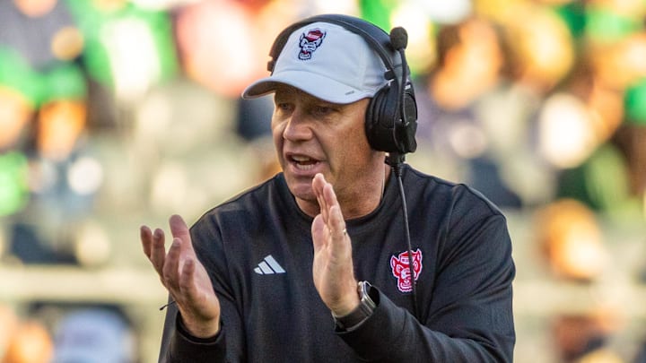 Oct 11, 2025; South Bend, Indiana, USA; NC State Wolfpack head coach Dave Doeren claps as he walks onto the field against the Notre Dame Fighting Irish during the second half at Notre Dame Stadium. Mandatory Credit: Michael Caterina-Imagn Images