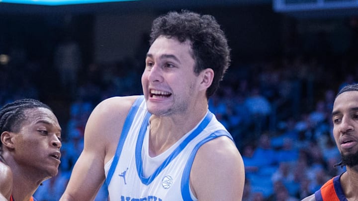 Mar 3, 2026; Chapel Hill, North Carolina, USA; Clemson Tigers forward RJ Godfrey (0) ties up the ball with North Carolina Tar Heels guard Luka Bogavac (44) during the second half at Dean E. Smith Center. Mandatory Credit: Scott Kinser-Imagn Images
