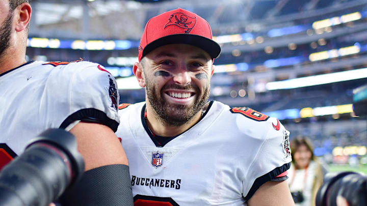 Dec 15, 2024; Inglewood, California, USA; Tampa Bay Buccaneers guard Ben Bredeson (68) and quarterback Baker Mayfield (6) celebrate the victory against the Los Angeles Chargers at SoFi Stadium. Mandatory Credit: Gary A. Vasquez-Imagn Images