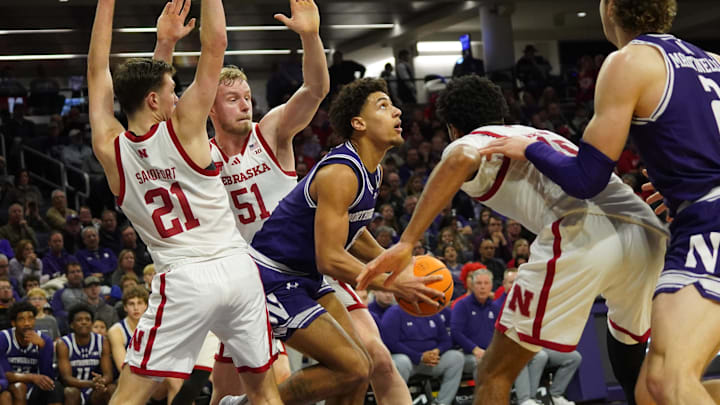 Nebraska's Rienk Mast (51) and Pryce Sandfort (21) defend against Northwestern's Tre Singleton (8).