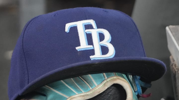 Sep 26, 2025; Toronto, Ontario, CAN; The hat and glove of Tampa Bay Rays third baseman Junior Caminero (13) in the dugout during the game against the Toronto Blue Jays at Rogers Centre. 