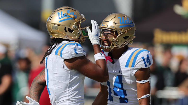 Aug 31, 2024; Honolulu, Hawaii, USA; UCLA Bruins wide receiver Rico Flores Jr. (1) reacts with defensive back Clint Stephens (14) after Flores Jr. made a touchdown against the Hawaii Rainbow Warriors during the third quarter of an NCAA college football game against the UCLA Bruins at the Clarence T.C. Ching Athletics Complex. Mandatory Credit: Marco Garcia-Imagn Images Aug 31, 2024; Honolulu, Hawaii, USA; UCLA Bruins wide receiver Rico Flores Jr. (1) reacts with defensive back Clint Stephens (14) after Flores Jr. made a touchdown against the Hawaii Rainbow Warriors during the third quarter of an NCAA college football game against the UCLA Bruins at the Clarence T.C. Ching Athletics Complex. Mandatory Credit: Marco Garcia-Imagn Images