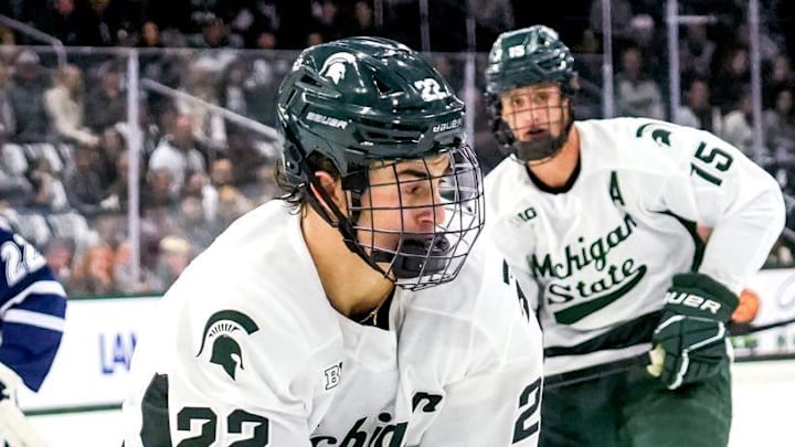 Michigan State's Porter Martone, right, moves the puck as New Hampshire's Conner de Haro closes in during the first period on Thursday, Oct. 9, 2025, at Munn Ice Arena in East Lansing.