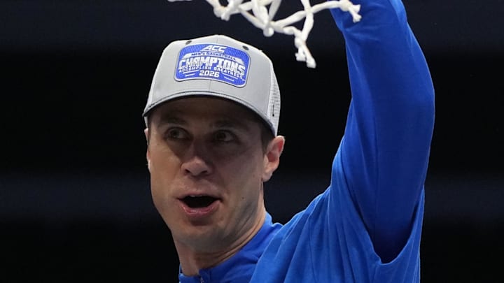 Mar 14, 2026; Charlotte, NC, USA; Duke Blue Devils head coach Jon Scheyer cuts down the net after defeating the Virginia Cavaliers in the men's ACC Conference Tournament Championship at Spectrum Center. Mandatory Credit: Bob Donnan-Imagn Images