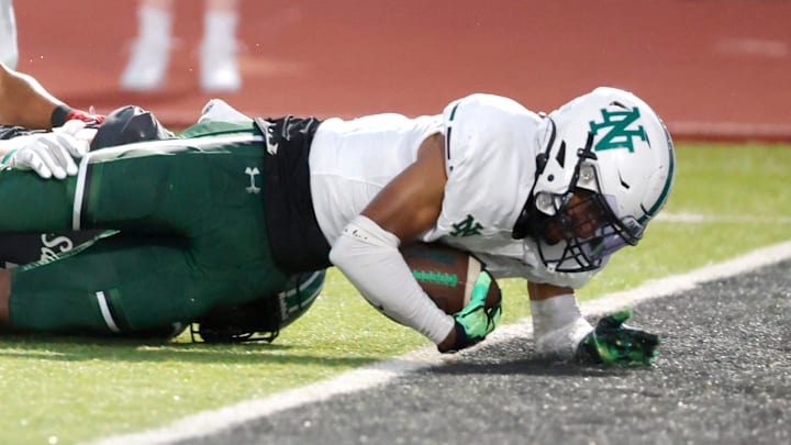 Norman North's Mason James scores a touchdown in front of Edmond Santa Fe's Franklin Sherrod during a high school football game between Edmond Santa Fe and Norman North in Edmond, Okla., Friday, Sept. 8, 2023.