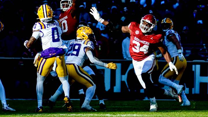 Oklahoma linebacker Kip Lewis and defensive end Adepoju Adebawore defend a pass against LSU. Oklahoma linebacker Kip Lewis and defensive end Adepoju Adebawore defend a pass against LSU.