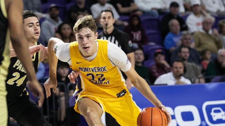 Cooper Flagg of Montverde Academy drives past Darren Harris of Paul VI at the City of Palms Classic on Friday, Dec. 22, 2023, at Suncoast Credit Union Arena in Fort Myers.