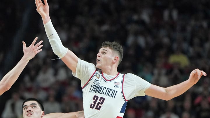 Apr 8, 2024; Glendale, AZ, USA; Connecticut Huskies forward Alex Karaban (11) and center Donovan Clingan (32) reaches for the ball against Purdue Boilermakers center Zach Edey (15) during the second half of the national championship game of the Final Four of the 2024 NCAA Tournament at State Farm Stadium. Mandatory Credit: Bob Donnan-USA TODAY Sports Apr 8, 2024; Glendale, AZ, USA; Connecticut Huskies forward Alex Karaban (11) and center Donovan Clingan (32) reaches for the ball against Purdue Boilermakers center Zach Edey (15) during the second half of the national championship game of the Final Four of the 2024 NCAA Tournament at State Farm Stadium. Mandatory Credit: Bob Donnan-USA TODAY Sports