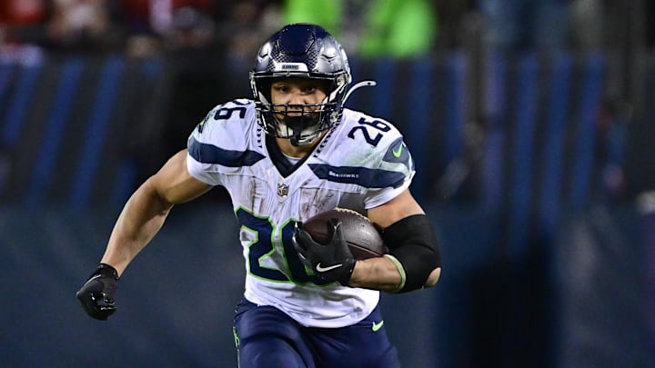 Dec 26, 2024; Chicago, Illinois, USA; Seattle Seahawks running back Zach Charbonnet (26) runs after a catch against the Chicago Bears during the fourth quarter at Soldier Field.