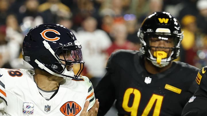 Chicago Bears quarterback Caleb Williams scrambles from Washington Commanders nose tackle Daron Payne.