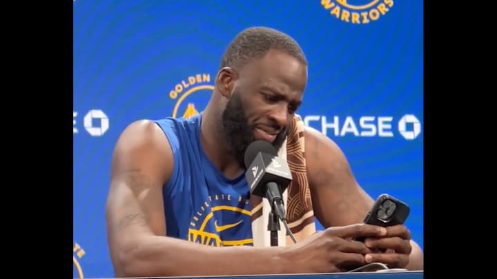 Draymond Green reads through texts from his mother during a press conference. 