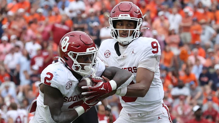 Oklahoma quarterback Michael Hawkins Jr. (9) and running back Jovantae Barnes