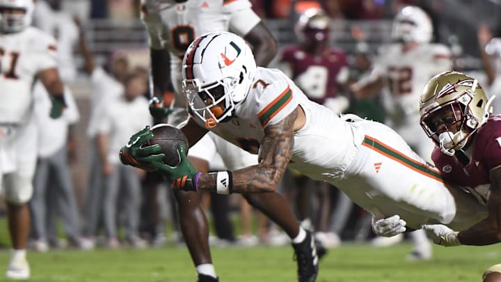 Oct 4, 2025; Tallahassee, Florida, USA; Miami Hurricanes wide receiver CJ Daniels (7) scores a touchdown against Florida State Seminoles defensive back Jerry Wilson (19) during the second half at Doak S. Campbell Stadium. Mandatory Credit: Robert Myers-Imagn Images