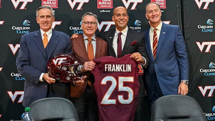 L-R, John Rocovich, Timothy Sands, James Franklin and Whit Babcock hold up a Virginia Tech jersey