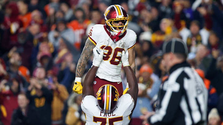 Nov 30, 2025; Landover, Maryland, USA; Washington Commanders running back Chris Rodriguez Jr. (36) celebrates after scoring a touchdown against the Denver Broncos with offensive tackle George Fant (77) in the second quarter of the game at Northwest Stadium. Mandatory Credit: Peter Casey-Imagn Images Nov 30, 2025; Landover, Maryland, USA; Washington Commanders running back Chris Rodriguez Jr. (36) celebrates after scoring a touchdown against the Denver Broncos with offensive tackle George Fant (77) in the second quarter of the game at Northwest Stadium. Mandatory Credit: Peter Casey-Imagn Images