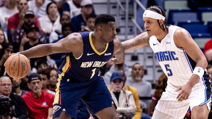 Apr 3, 2024; New Orleans, Louisiana, USA;  New Orleans Pelicans forward Zion Williamson (1) dribbles against Orlando Magic forward Paolo Banchero (5) during the first half at Smoothie King Center. Mandatory Credit: Stephen Lew-Imagn Images