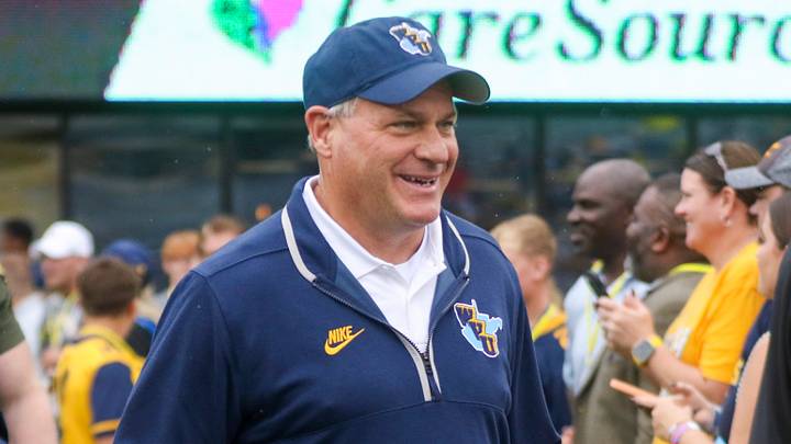 Sep 27, 2025; Morgantown, West Virginia, USA; West Virginia Mountaineers head coach Rich Rodriguez walks on the field and greets fans before their game against the Utah Utes at Milan Puskar Stadium. Mandatory Credit: Ben Queen-Imagn Images