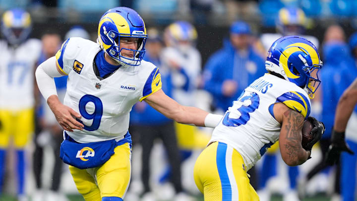 Nov 30, 2025; Charlotte, North Carolina, USA; Los Angeles Rams quarterback Matthew Stafford (9) hands the ball off to Los Angeles Rams running back Kyren Williams (23) during the fourth quarter against the Carolina Panthers at Bank of America Stadium. Mandatory Credit: Jim Dedmon-Imagn Images