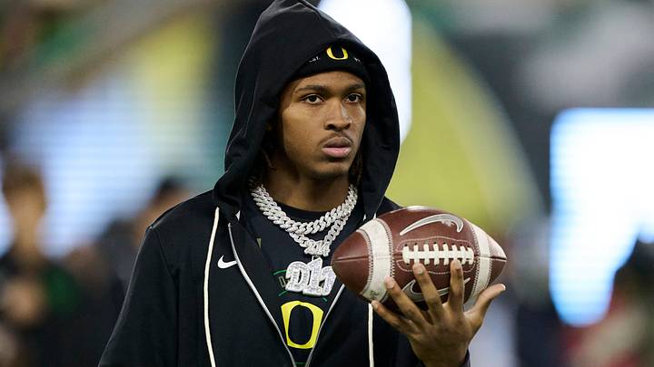 Nov 14, 2025; Eugene, Oregon, USA; Oregon Ducks wide receiver Dakorien Moore watches teammates warm up before a game against the Minnesota Golden Gophers at Autzen Stadium. Mandatory Credit: Troy Wayrynen-Imagn Images Nov 14, 2025; Eugene, Oregon, USA; Oregon Ducks wide receiver Dakorien Moore watches teammates warm up before a game against the Minnesota Golden Gophers at Autzen Stadium. Mandatory Credit: Troy Wayrynen-Imagn Images