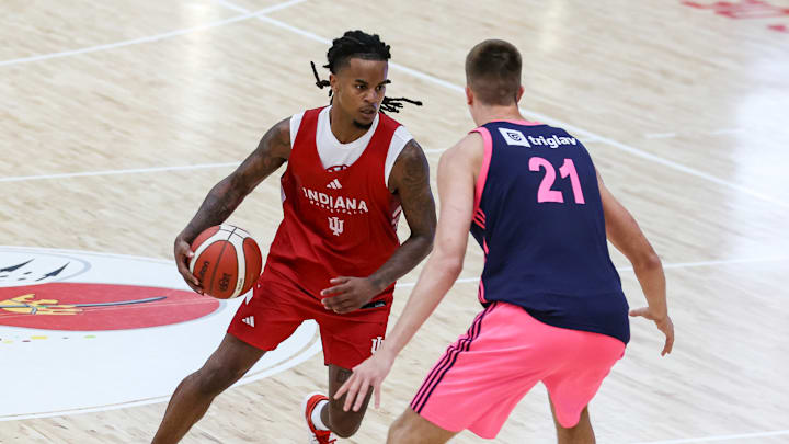 Indiana basketball guard Lamar Wilkerson dribbles in front of Mega Superbet and Milwaukee Bucks forward Bogoljub Marković.