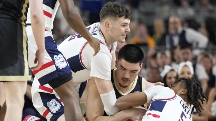 Connecticut Huskies center Donovan Clingan (32) and guard Stephon Castle (5) battle Purdue Boilermakers center Zach Edey (15) for the ball during the Men's NCAA national championship game at State Farm Stadium in Glendale on April 8, 2024. Connecticut Huskies center Donovan Clingan (32) and guard Stephon Castle (5) battle Purdue Boilermakers center Zach Edey (15) for the ball during the Men's NCAA national championship game at State Farm Stadium in Glendale on April 8, 2024.