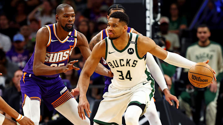 Mar 24, 2025; Phoenix, Arizona, USA; Milwaukee Bucks forward Giannis Antetokounmpo (34) handles the ball against Phoenix Suns forward Kevin Durant (35) during the second quarter at Footprint Center. Mandatory Credit: Mark J. Rebilas-Imagn Images