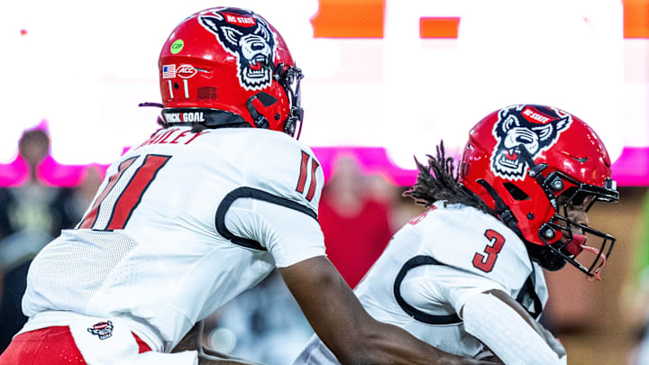 Sep 11, 2025; Winston-Salem, North Carolina, USA; North Carolina State Wolfpack quarterback CJ Bailey (11) hands off to Hollywood Smothers (3) in the first half against the Wake Forest Demon Deacons at Allegacy Federal Credit Union Stadium. Mandatory Credit: Luke Jamroz-Imagn Images Sep 11, 2025; Winston-Salem, North Carolina, USA; North Carolina State Wolfpack quarterback CJ Bailey (11) hands off to Hollywood Smothers (3) in the first half against the Wake Forest Demon Deacons at Allegacy Federal Credit Union Stadium. Mandatory Credit: Luke Jamroz-Imagn Images