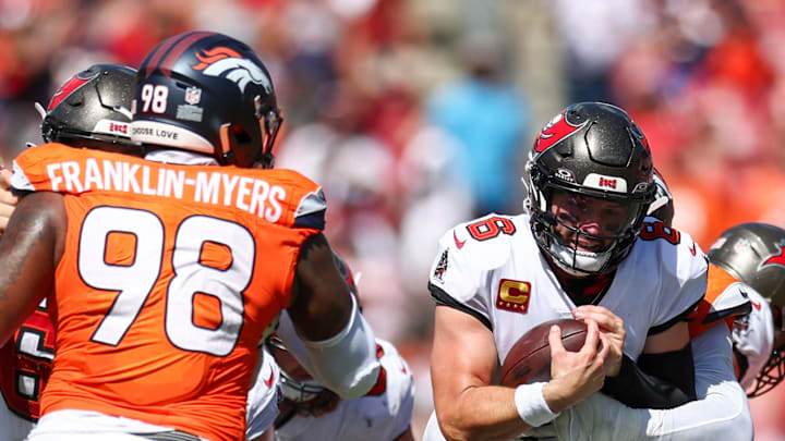 Sep 22, 2024; Tampa, Florida, USA; Tampa Bay Buccaneers quarterback Baker Mayfield (6) is sacked by Denver Broncos linebacker Jonathon Cooper (0) in the fourth quarter at Raymond James Stadium. Mandatory Credit: Nathan Ray Seebeck-Imagn Images
