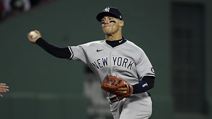Oct 5, 2021; Boston, Massachusetts, USA; Boston Red Sox right fielder Hunter Renfroe (10) is out at second as New York Yankees shortstop Andrew Velazquez (71) throws to first for the out against catcher Kevin Plawecki (25) during the fourth inning of the American League Wildcard game at Fenway Park. Mandatory Credit: Bob DeChiara-Imagn Images