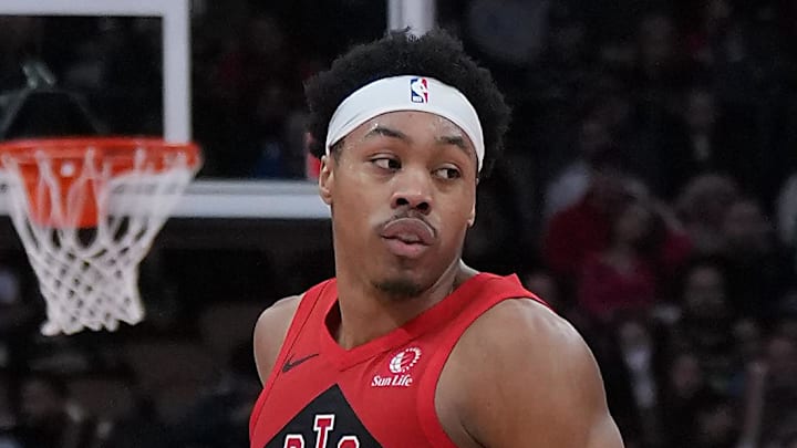Toronto Raptors forward Scottie Barnes controls the ball as Orlando Magic forward Paolo Banchero tries to defend.