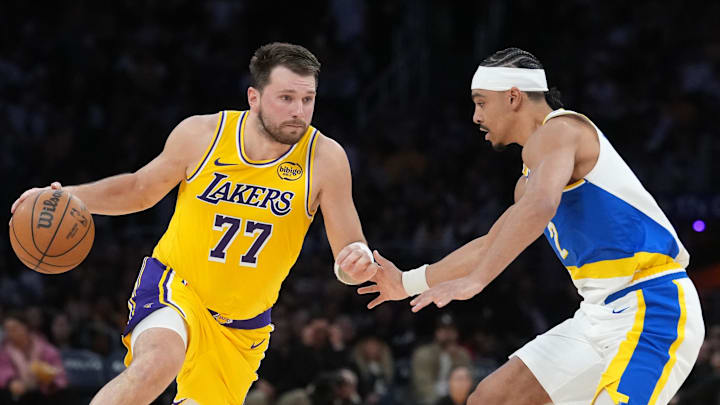 Mar 6, 2026; Los Angeles, California, USA; Los Angeles Lakers guard Luka Doncic (77) dribbles against Indiana Pacers guard Andrew Nembhard (2) in the first half at Crypto.com Arena. Mandatory Credit: Kirby Lee-Imagn Images