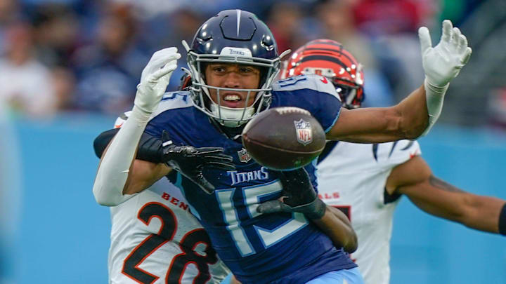 Tennessee Titans wide receiver Nick Westbrook-Ikhine (15) is hit by Cincinnati Bengals cornerback Josh Newton (28) as the pass arrives during the second quarter at Nissan Stadium in Nashville, Tenn., Sunday, Dec. 15, 2024. The ball was knocked into the air and intercepted by Cincinnati.