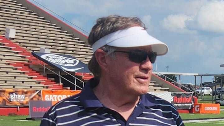 Bill Belichick, left, talks with Peyton Manning, right, at the 2024 Manning Passing Academy.