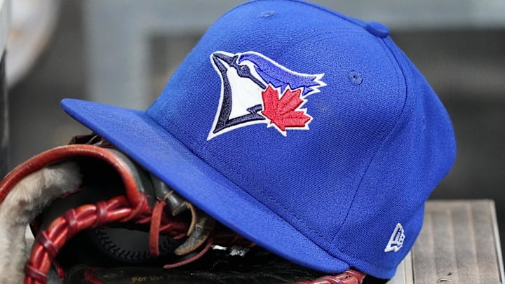 Apr 16, 2025; Toronto, Ontario, CAN; A Toronto Blue Jays hat and glove in the dugout during a game against the Atlanta Braves at Rogers Centre. 
