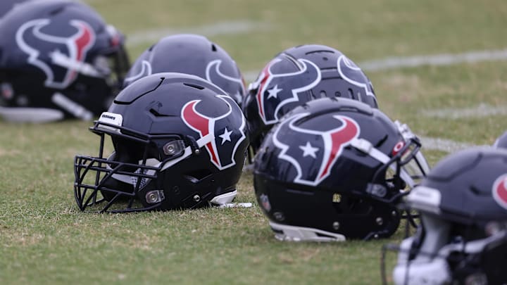 May 24, 2022; Houston, Texas, USA; Houston Texans helmets lay on the turf during organized team activities at the Houston Texans practice field. Mandatory Credit: Thomas Shea-Imagn Images