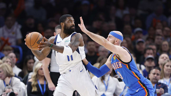 Jan 23, 2025; Oklahoma City, Oklahoma, USA; Dallas Mavericks guard Kyrie Irving (11) is defended by Oklahoma City Thunder guard Alex Caruso (9) on as he passes during the second half at Paycom Center. Mandatory Credit: Alonzo Adams-Imagn Images