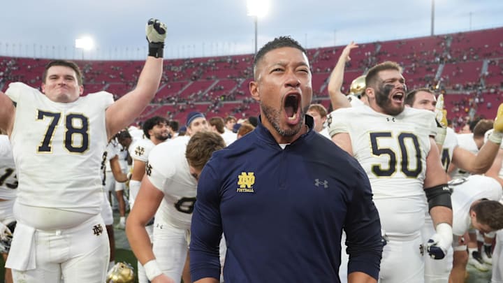 Nov 30, 2024; Los Angeles, California, USA; Notre Dame Fighting Irish head coach Marcus Freeman celebrates with players at the end of the game against the Southern California Trojans at United Airlines Field at Los Angeles Memorial Coliseum. 
