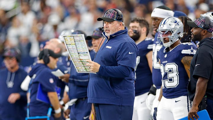 Dallas Cowboys Head Coach Mike McCarthy looks over the play chart during the first quarter against the Detroit Lions Dallas Cowboys Head Coach Mike McCarthy looks over the play chart during the first quarter against the Detroit Lions