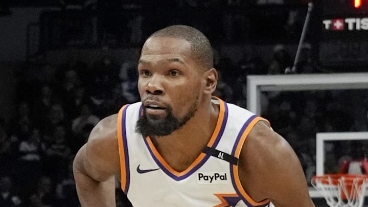 Mar 28, 2025; Minneapolis, Minnesota, USA; Phoenix Suns forward Kevin Durant (35) brings the ball up as Minnesota Timberwolves guard Anthony Edwards (5) defends him in the fourth quarter at Target Center. Mandatory Credit: Bruce Kluckhohn-Imagn Images