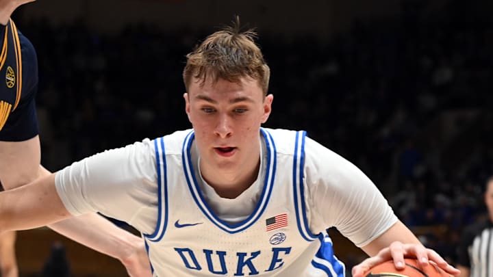 Feb 12, 2025; Durham, North Carolina, USA; Duke Blue Devils forward Cooper Flagg (2) controls the ball in front of California Golden Bears forward Rytis Petraitis (31) during the second half at Cameron Indoor Stadium. Mandatory Credit: Rob Kinnan-Imagn Images