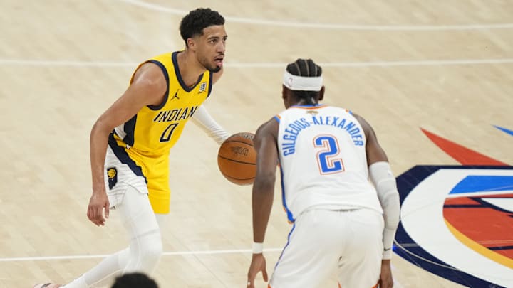 Jun 5, 2025; Oklahoma City, Oklahoma, USA; Indiana Pacers guard Tyrese Haliburton (0) dribbles the ball against Oklahoma City Thunder guard Shai Gilgeous-Alexander (2) during the third quarter in game one of the 2025 NBA Finals at Paycom Center. Mandatory Credit: Kyle Terada-Imagn Images