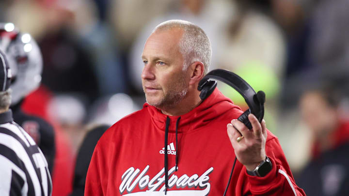 Nov 21, 2024; Atlanta, Georgia, USA; North Carolina State Wolfpack head coach Dave Doeren talks to a referee against the Georgia Tech Yellow Jackets in the fourth quarter at Bobby Dodd Stadium at Hyundai Field. Mandatory Credit: Brett Davis-Imagn Images